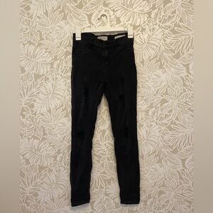 Black ripped skinny jeans.